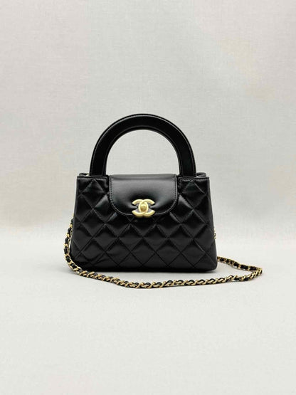 Pre - loved CHANEL Kelly Black Quilted Top Handle at Reems Closet