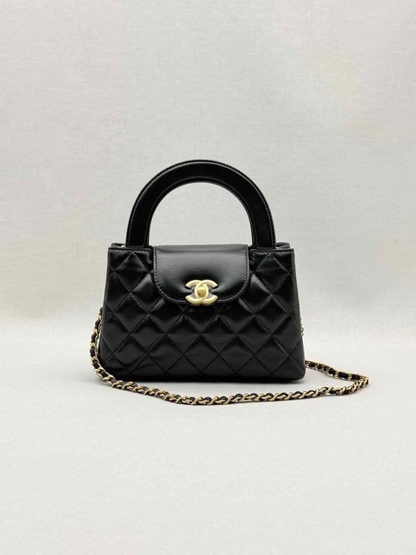 Pre - loved CHANEL Kelly Black Quilted Top Handle at Reems Closet