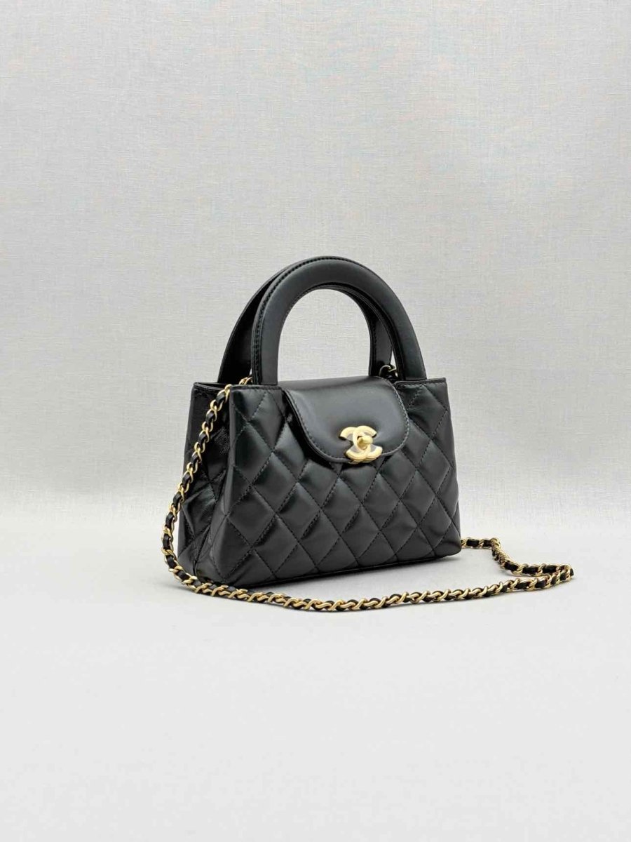 Pre - loved CHANEL Kelly Black Quilted Top Handle at Reems Closet