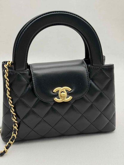 Pre - loved CHANEL Kelly Black Quilted Top Handle at Reems Closet