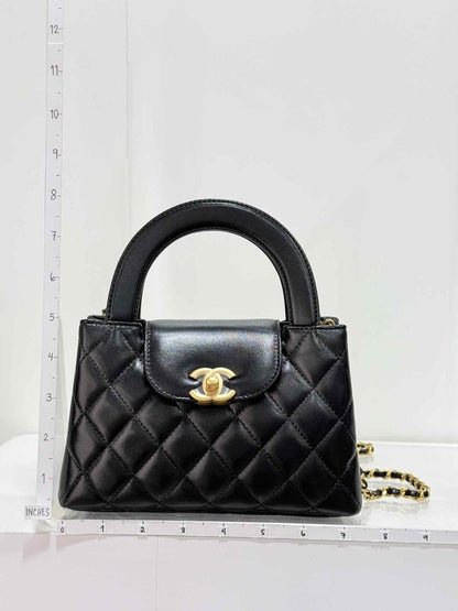 Pre - loved CHANEL Kelly Black Quilted Top Handle at Reems Closet