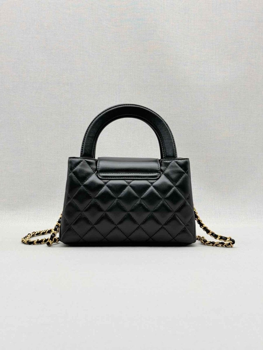 Pre - loved CHANEL Kelly Black Quilted Top Handle at Reems Closet