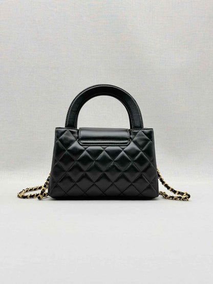 Pre - loved CHANEL Kelly Black Quilted Top Handle at Reems Closet