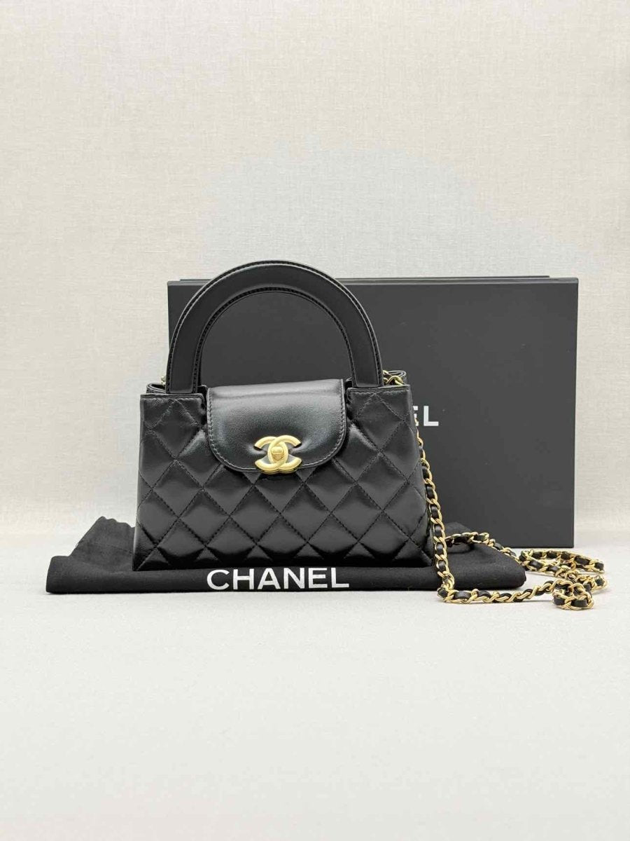 Pre - loved CHANEL Kelly Black Quilted Top Handle at Reems Closet