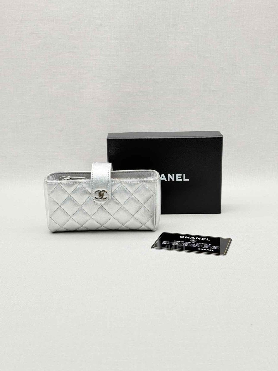 Pre-loved CHANEL Metallic Silver Quilted Phone case at Reems Closet