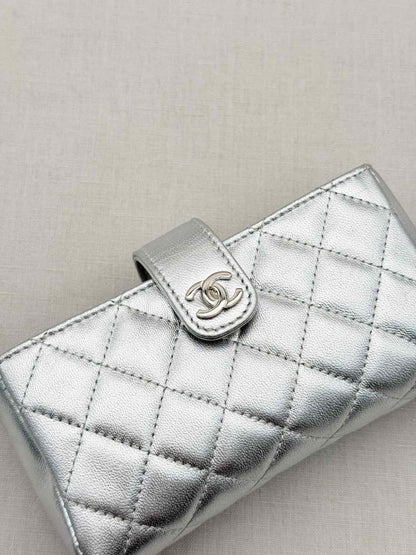 Pre-loved CHANEL Metallic Silver Quilted Phone case at Reems Closet