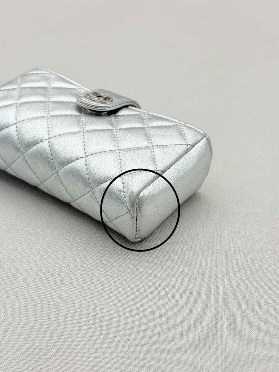 Pre-loved CHANEL Metallic Silver Quilted Phone case at Reems Closet