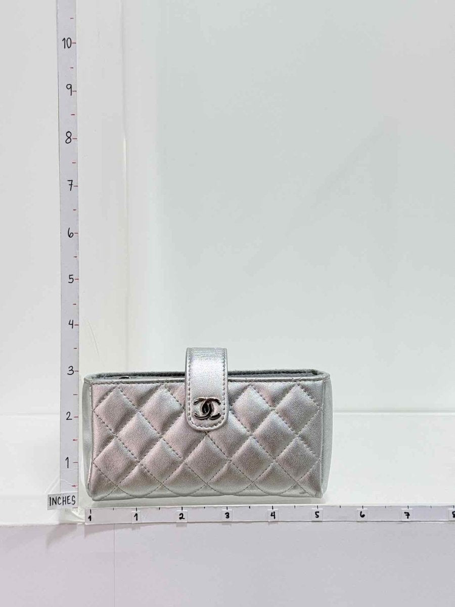 Pre-loved CHANEL Metallic Silver Quilted Phone case at Reems Closet