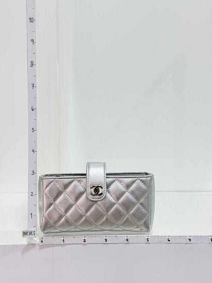 Pre-loved CHANEL Metallic Silver Quilted Phone case at Reems Closet