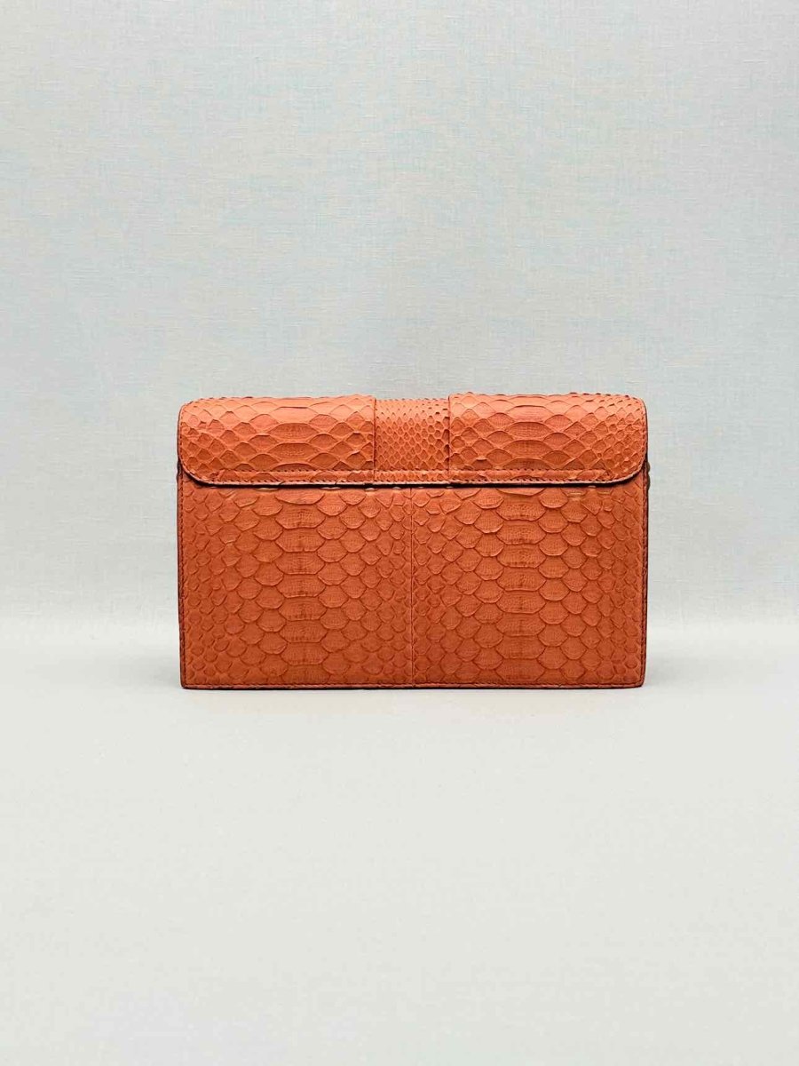 Pre-loved KNEED Coco Orange Clutch at Reems Closet