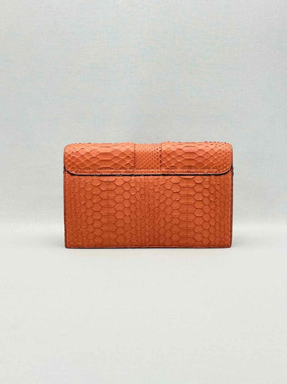 Pre-loved KNEED Coco Orange Clutch at Reems Closet