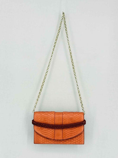 Pre-loved KNEED Coco Orange Clutch at Reems Closet