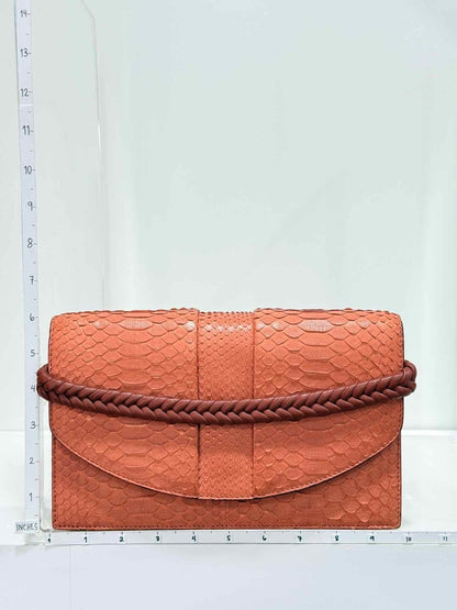 Pre-loved KNEED Coco Orange Clutch at Reems Closet