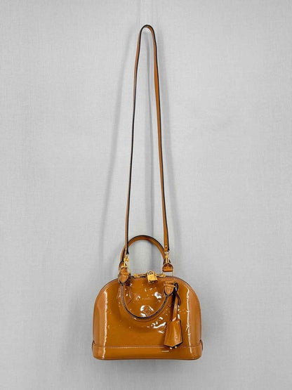 Pre-loved LOUIS VUITTON Alma Tan Monogram Top Handle at Reems Closet