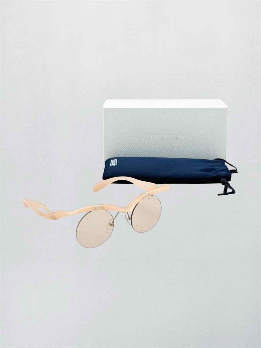 Pre-loved PRADA Peach Sunglasses at Reems Closet