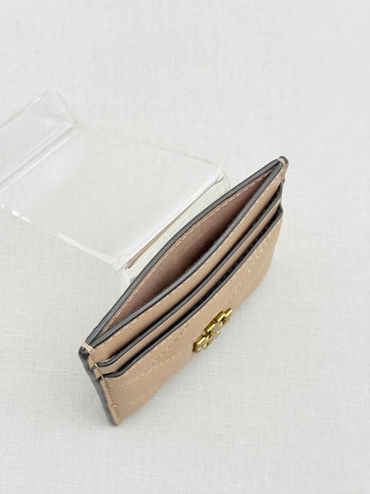 Pre-loved TORY BURCH Beige Chevron Quilted Card Case at Reems Closet